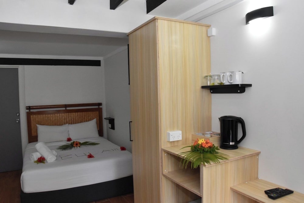 A garden-view room at Bulabard Villas